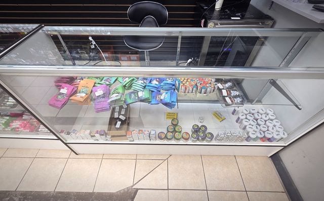 Rolling papers and wraps under the counter glass.