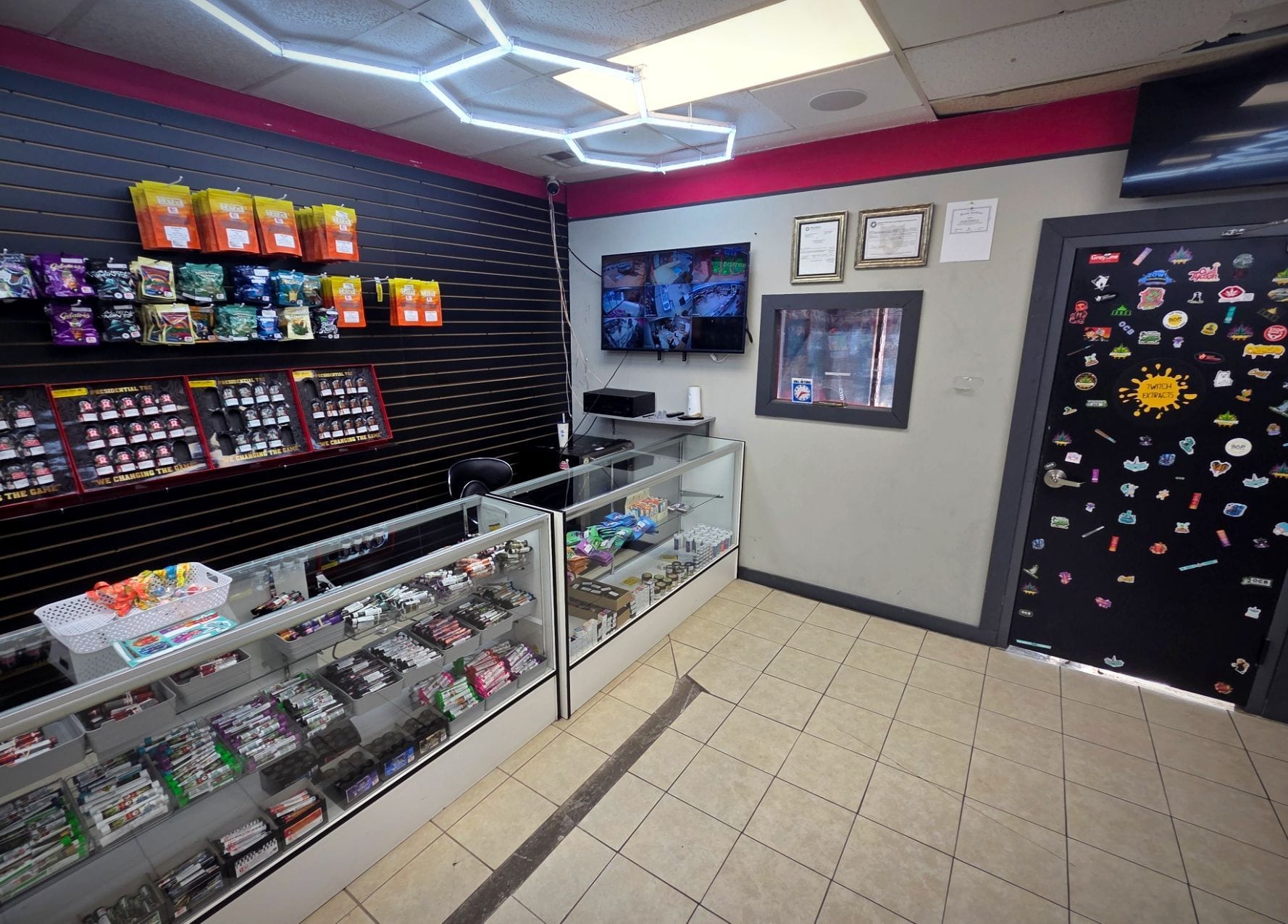 The entrance area, with state licensing certificates framed on the wall beside the counter.